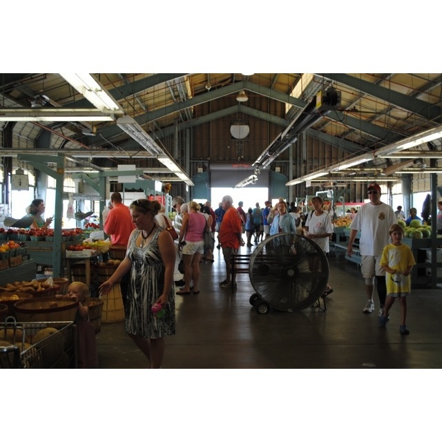 In the foreground, Elizabeth and Taylor Mac Johnson explore the many market booths and displays.